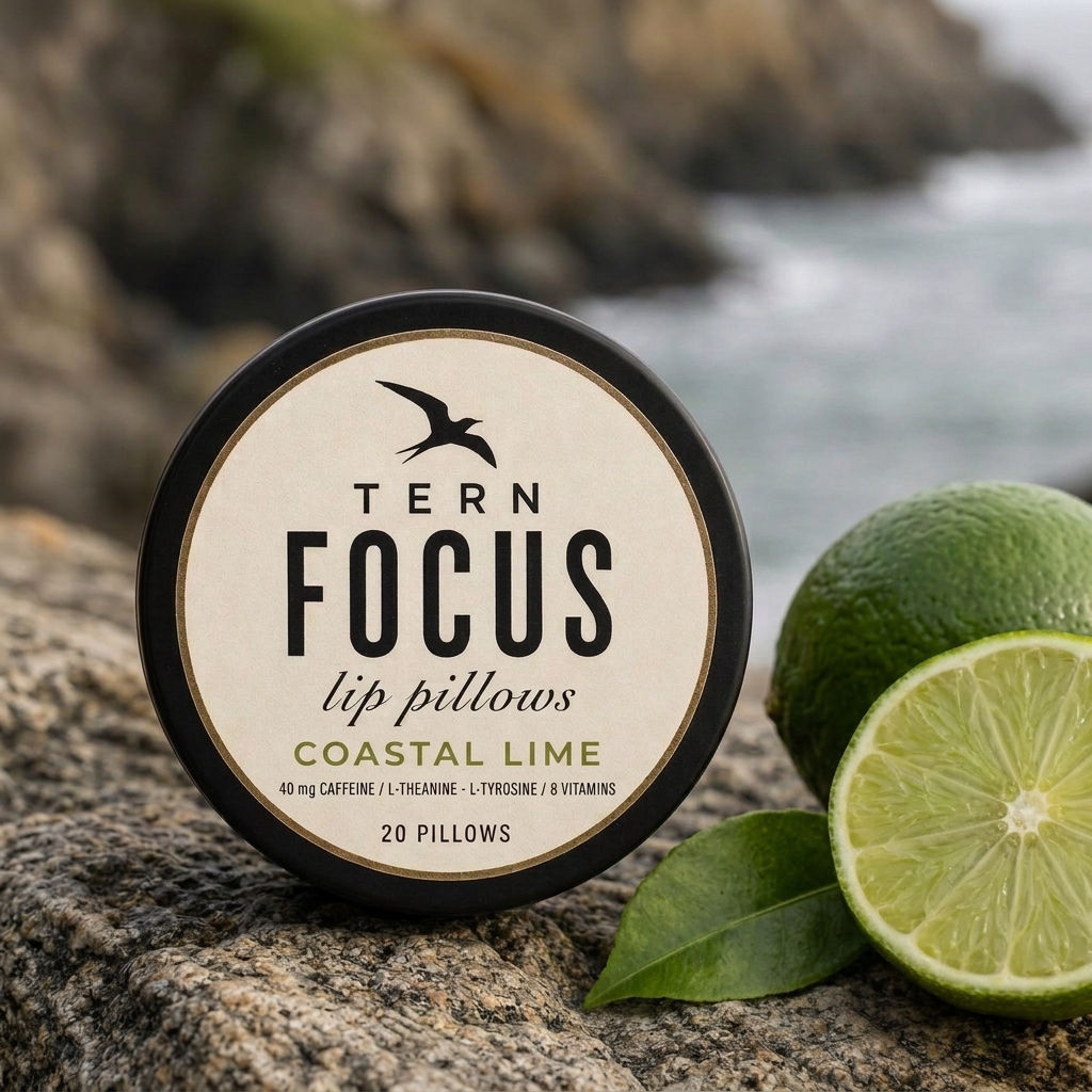 TERN FOCUS lip pillows in Coastal Lime beside a fresh lime by the sea